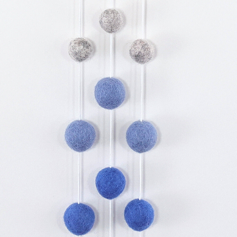 100% organic light grey color yarn is hand wrapped around our airplane shape baltic birch wood frame. Five natural wool felt poms are threaded on each of the three cotton threads that are attached to the bottom of the airplane. Star shaped felt pom is hanging from the top of the airplane.